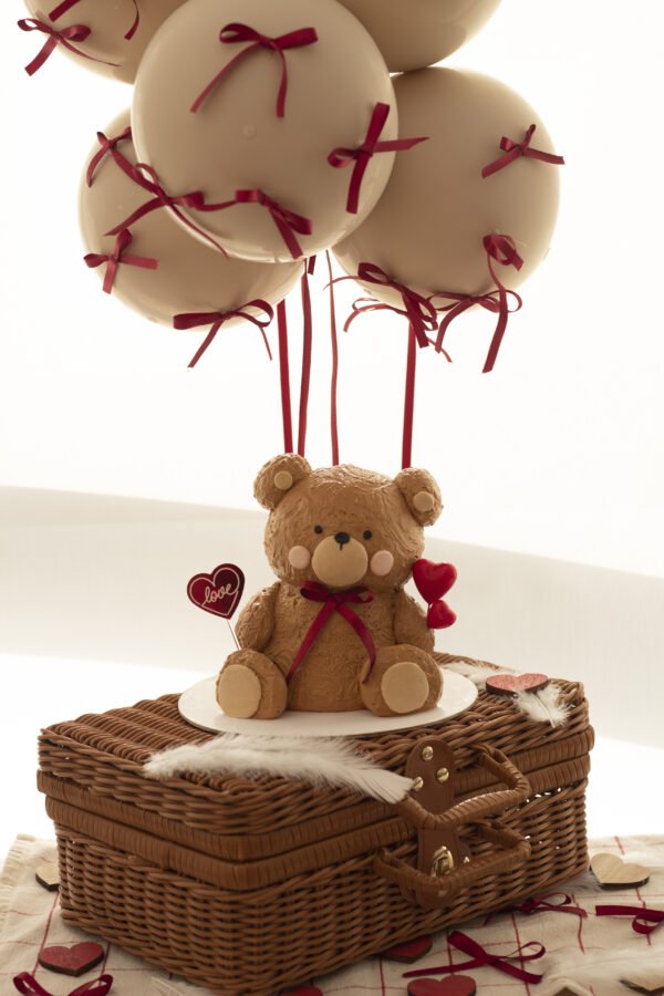 a bear made of cake sitting on a basket